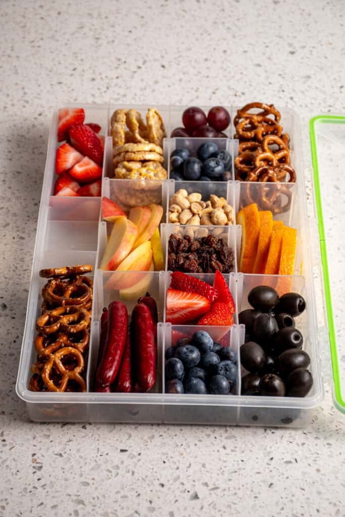 A snackle box filled with food.