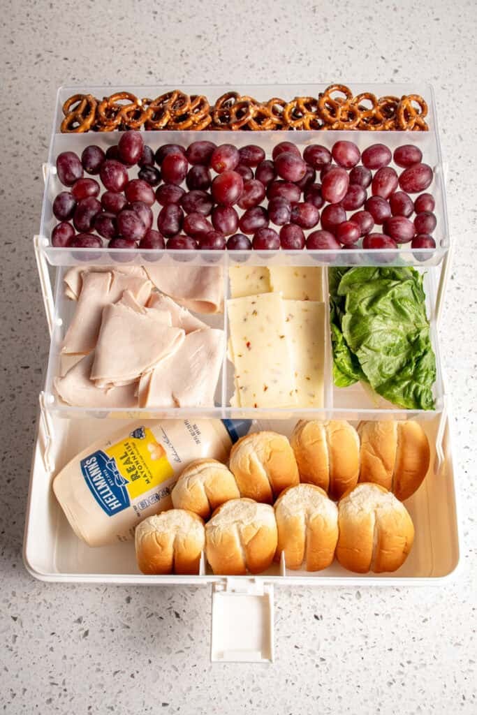 A snack tackle box filled with sandwich makings.
