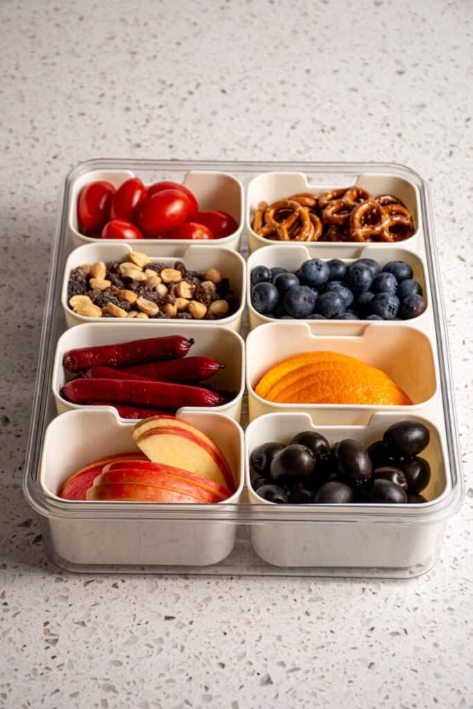 Snack box container filled with a bunch of different foods.