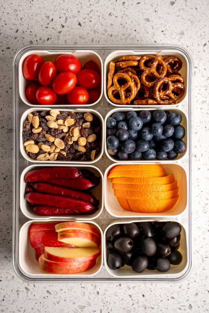 Snack box container filled with a bunch of different foods.