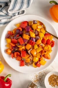 Colorful Grilled Peppers and Onions on a white plate.