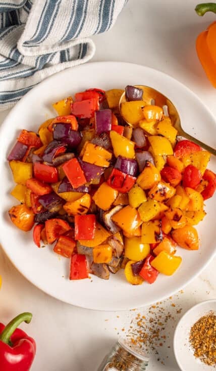 Colorful Grilled Peppers and Onions on a white plate.