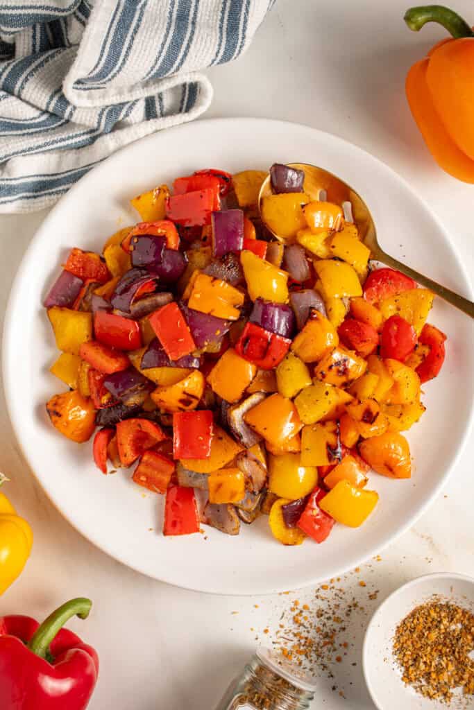 Colorful Grilled Peppers and Onions on a white plate.