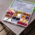 A snackle box filled with all different types of snacks.