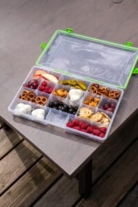 A snackle box filled with all different types of snacks.