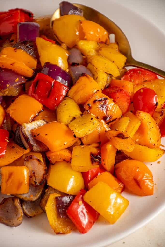 Colorful Grilled Peppers and Onions on a white plate.
