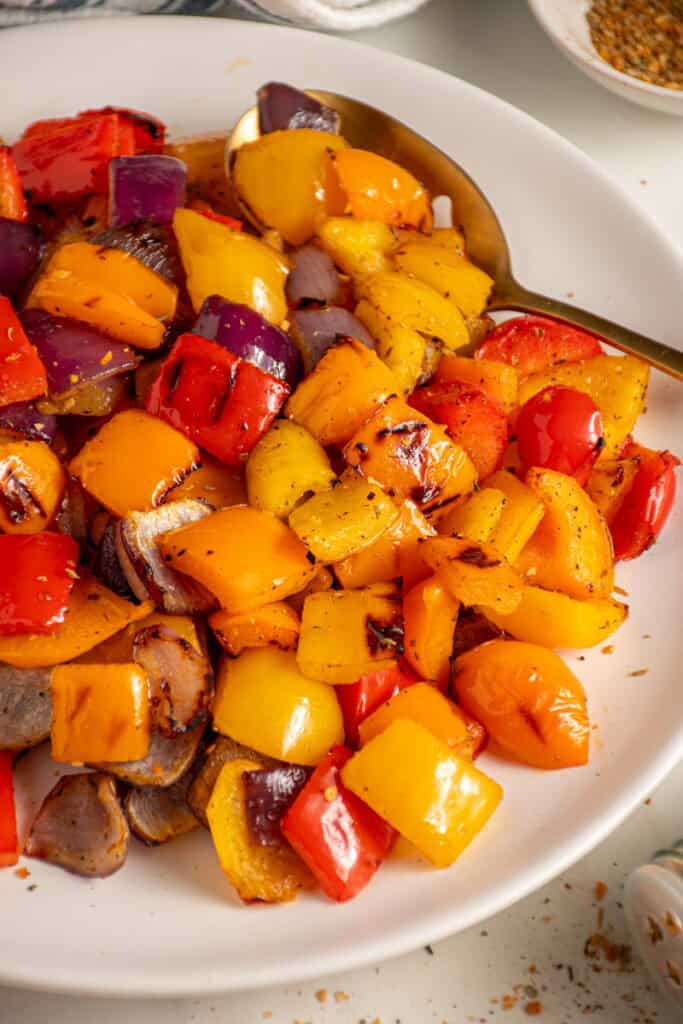 Colorful Grilled Peppers and Onions on a white plate.