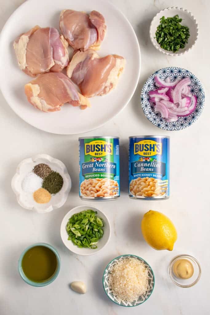 Ingredients laid out for making dense white bean salad with grilled chicken.