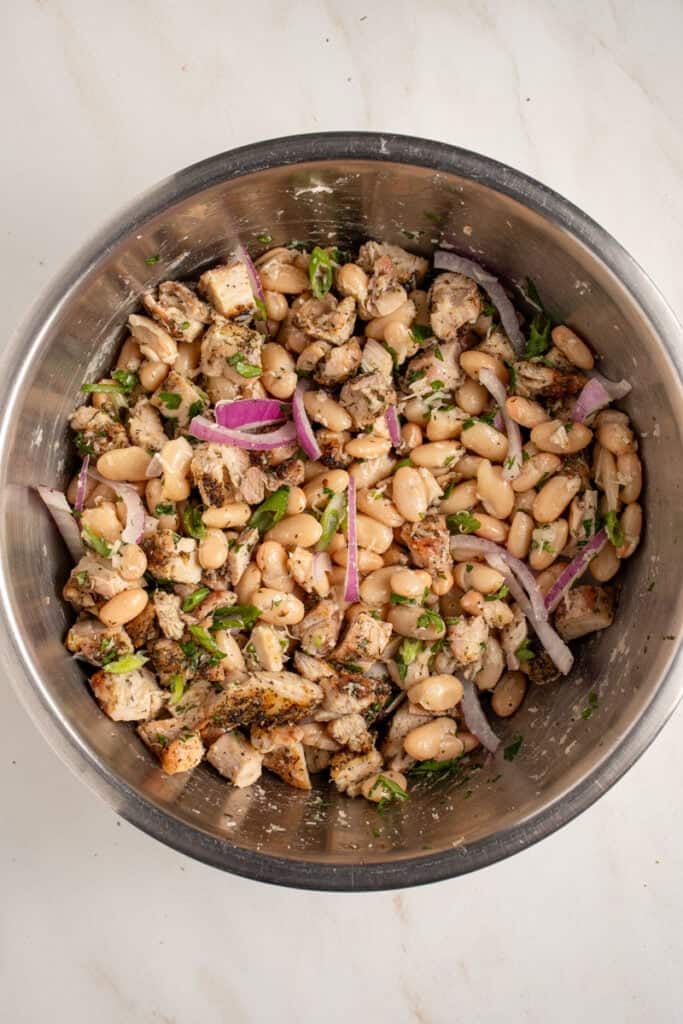 Mixing together the ingredients for dense white bean salad.