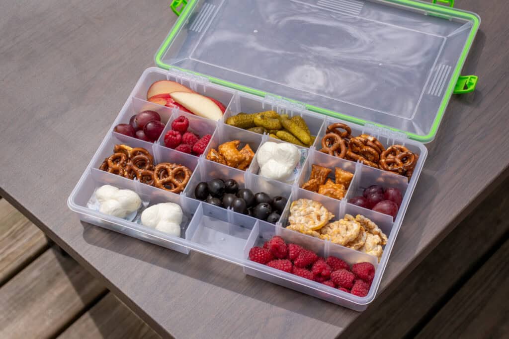 A snackle box filled with all different types of snacks.