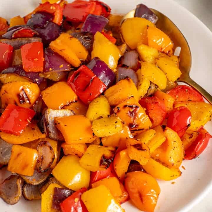 Colorful Grilled Peppers and Onions on a white plate.