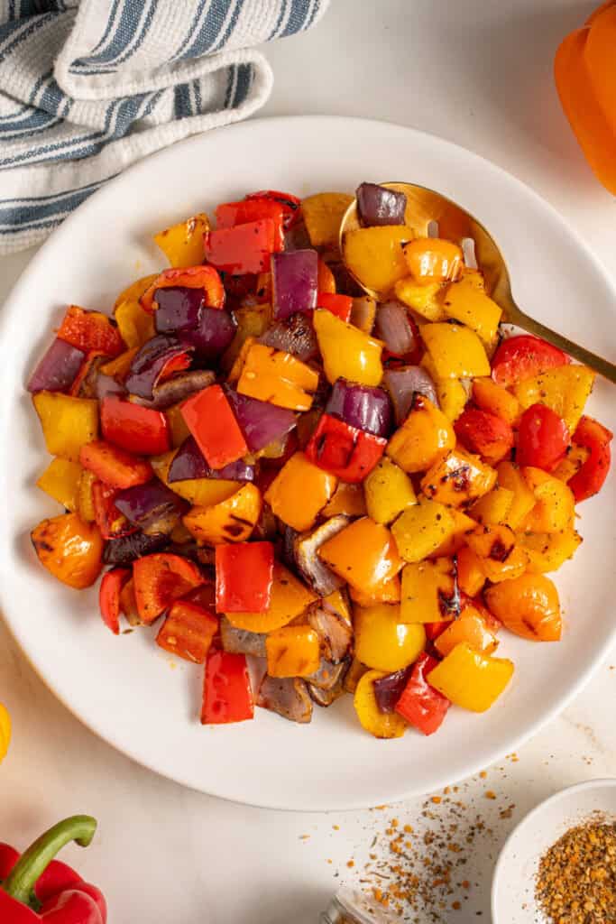Colorful Grilled Peppers and Onions on a white plate.