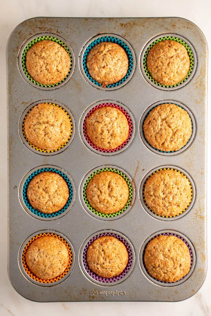 Baked whole wheat banana muffins in a muffin tin.