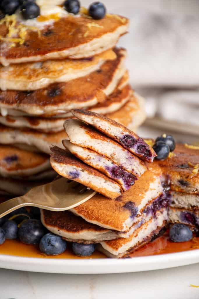 A bite of lemon blueberry pancakes on a fork.
