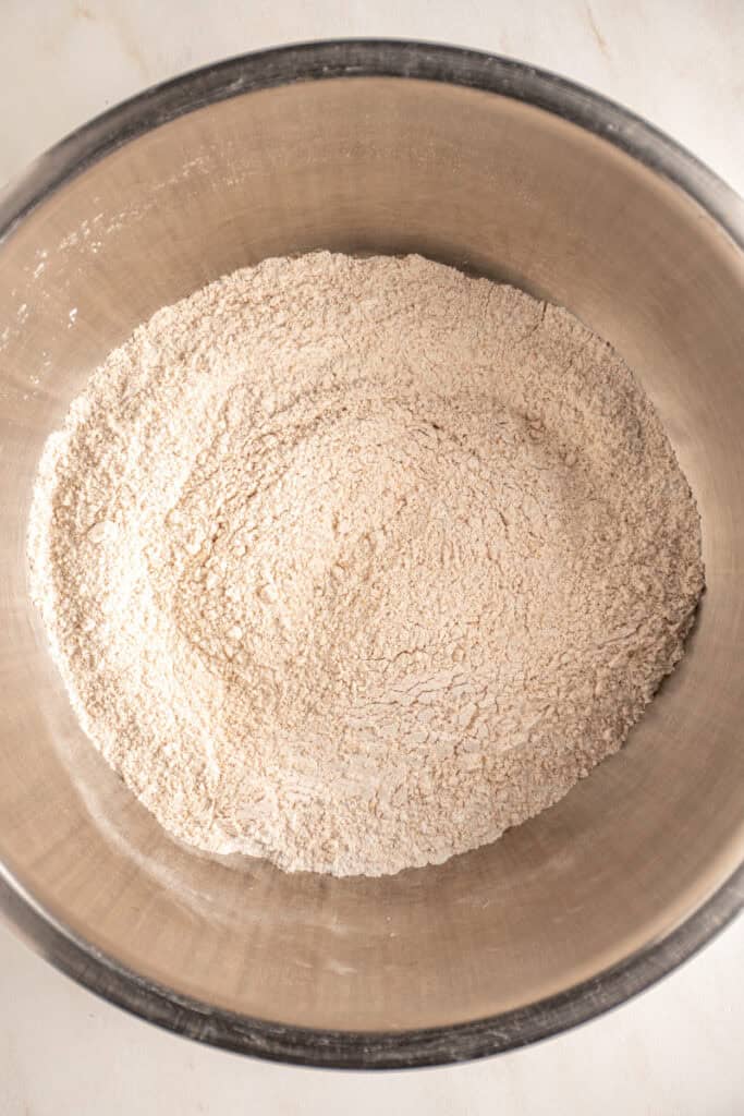 Mixed dry ingredients in a mixing bowl to make whole wheat banana muffins.