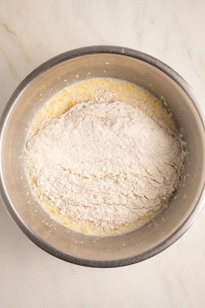 Dry ingredients being added to the wet ingredients to make pancake batter.