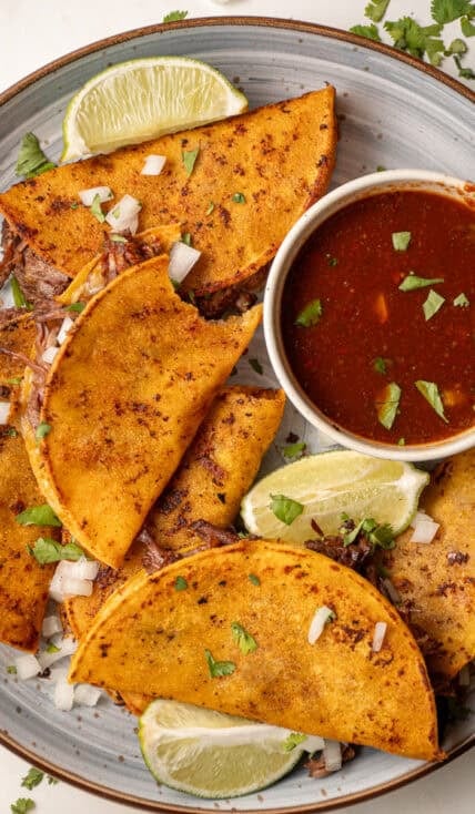 A plate of birria tacos made in the slow cooker.